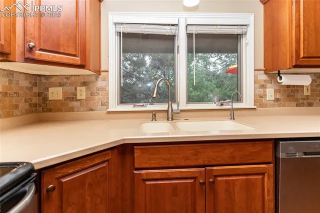 a kitchen with stainless steel appliances a refrigerator and a stove top oven