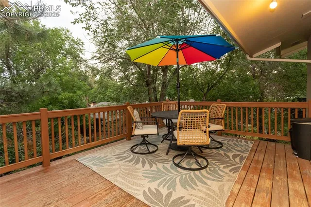 a view of deck with table and chair under an umbrella
