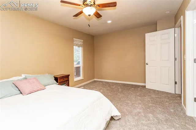 a bedroom with a bed and a ceiling fan