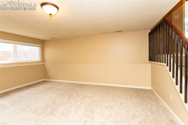 a view of a livingroom with a furniture and staircase