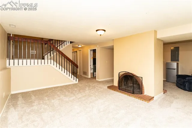 a view of an empty room with stairs