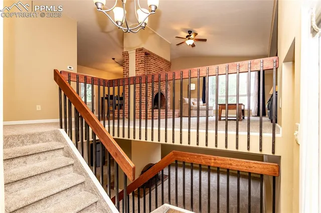 a view of staircase with railing and a window