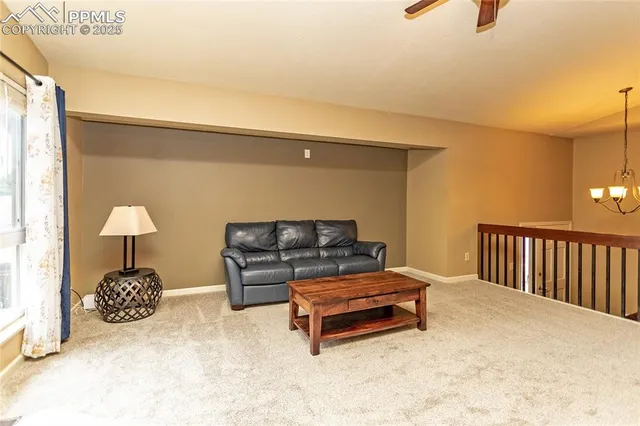 a living room with furniture a fireplace and a large window