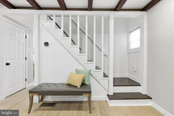 a view of entryway and hall with wooden floor