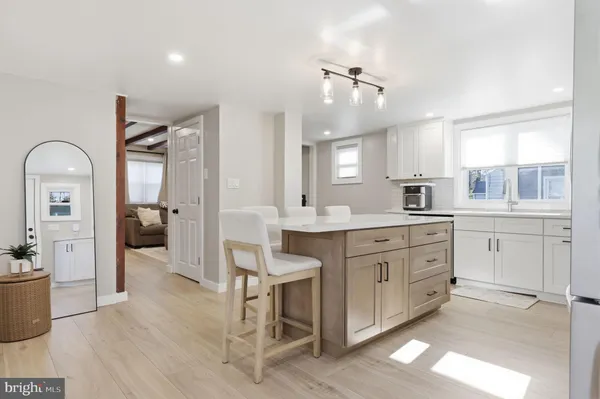 a kitchen with a white cabinets and chandelier