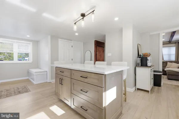 a spacious bathroom with a double vanity sink a large mirror and a bathtub