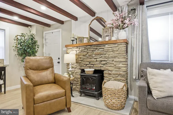 a living room with furniture a fireplace and a chandelier