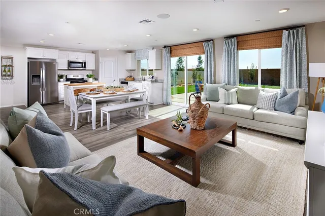 a kitchen with a stove and wooden floor