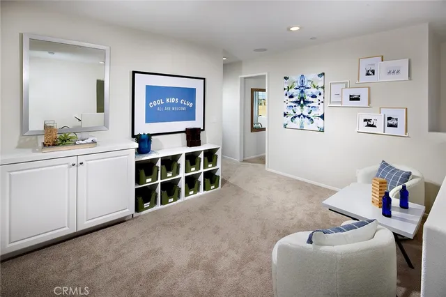 a bedroom with a bed and a flat tv screen on dresser