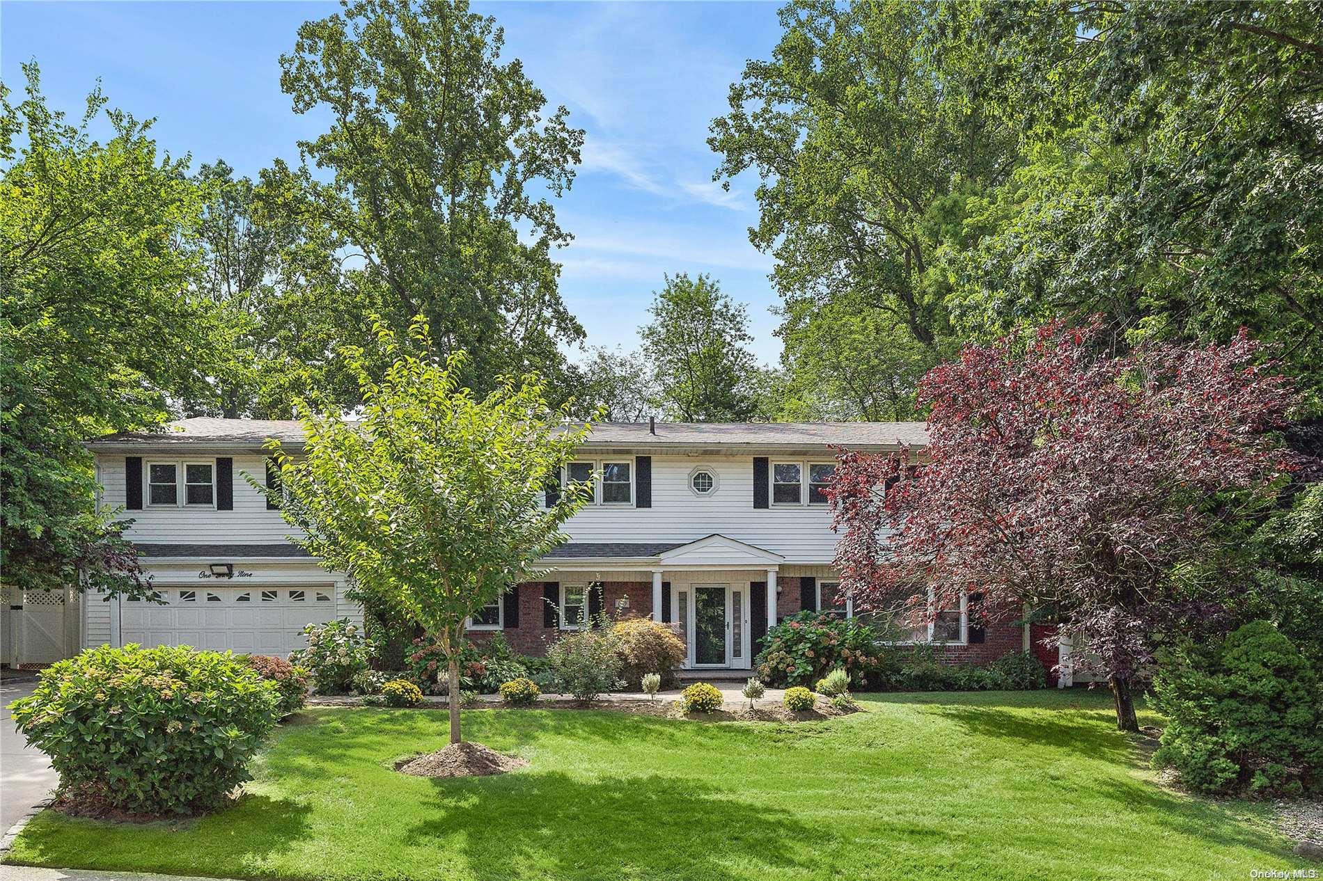 139 Chestnut Road Manhasset, NY 11030 - Photo 1 of 1 front view of a house with a yard
