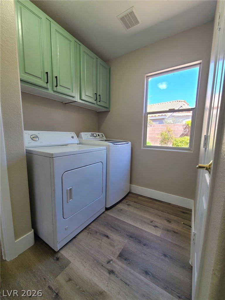 2278 Chestnut Ranch Avenue Henderson, NV 89052 - Photo 15 of 18 Ample cabinetry and modern appliances create a practical and efficient laundry area.