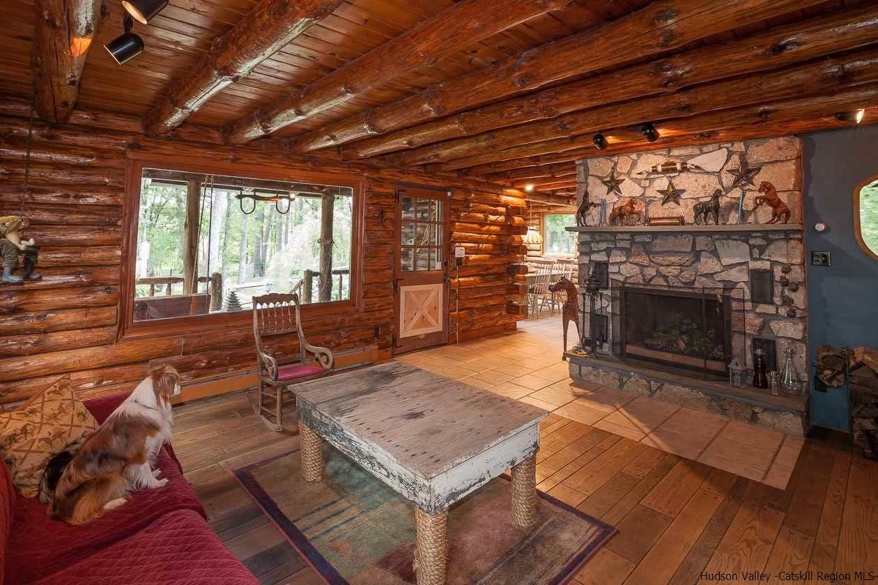 276 Krum Road Kerhonkson, NY 12446 - Photo 6 of 34 a living room with a fireplace furniture and a large window