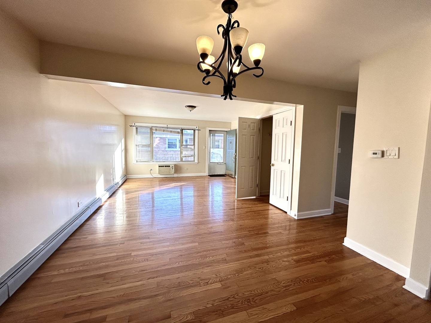 4342 North Kedvale Avenue, Unit 2A Chicago, IL 60641 - Photo 15 of 23 a view of a room with wooden floor chandelier and windows