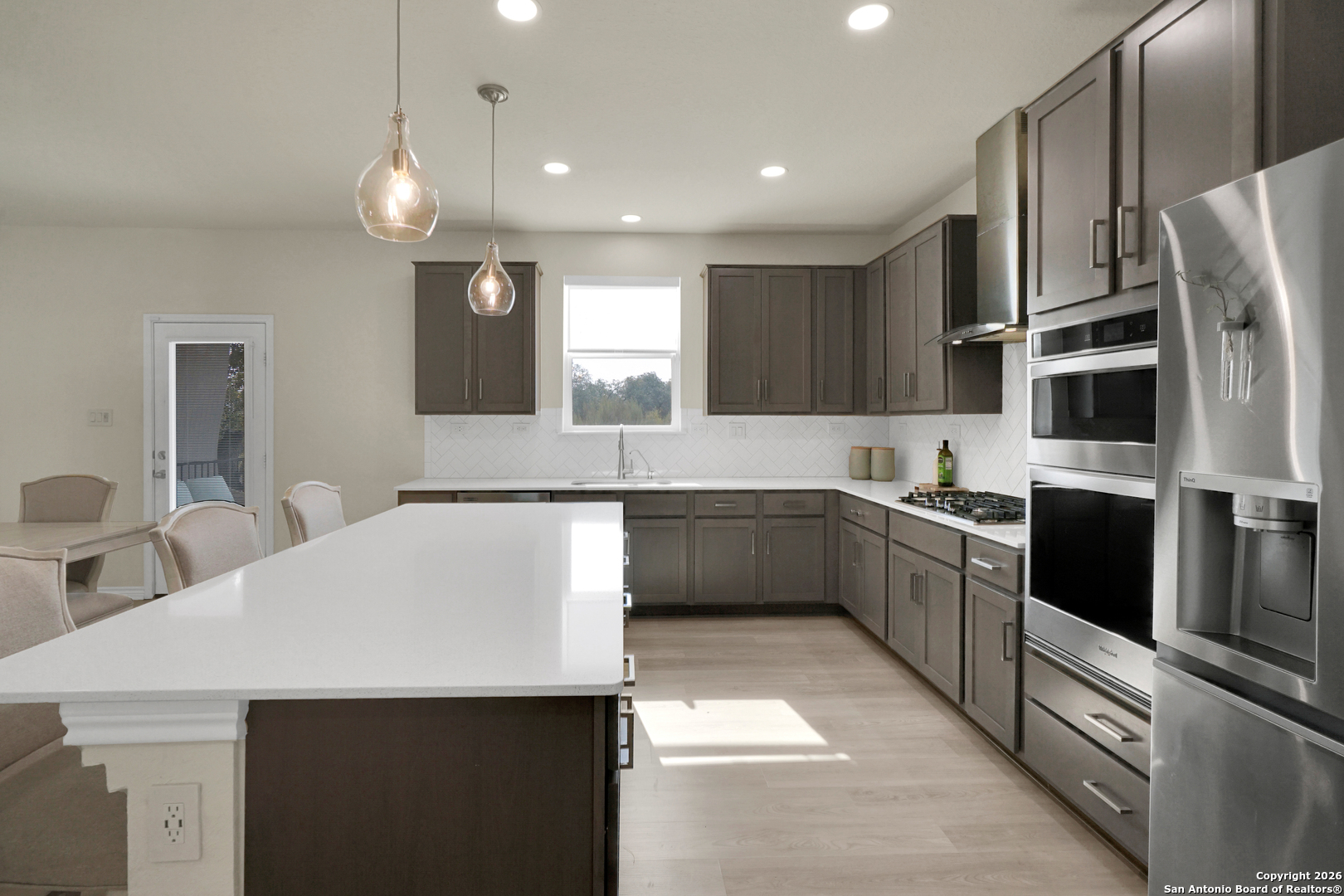 3634 Marvel Bulverde, TX 78163 - Photo 17 of 42 a kitchen with stainless steel appliances a microwave a sink and a refrigerator