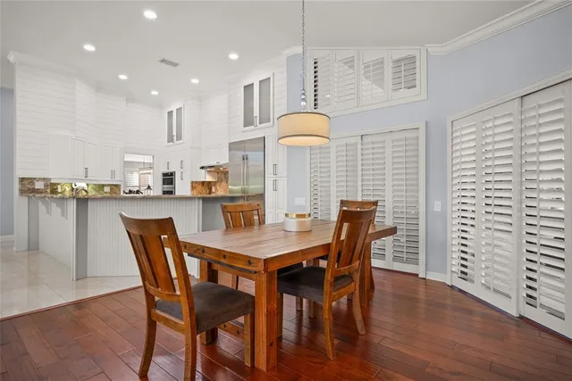 a dining room with furniture and wooden floor