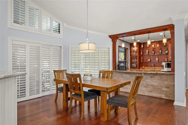a dining room with furniture and wooden floor
