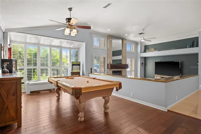 a living room with furniture a flat screen tv and a large window