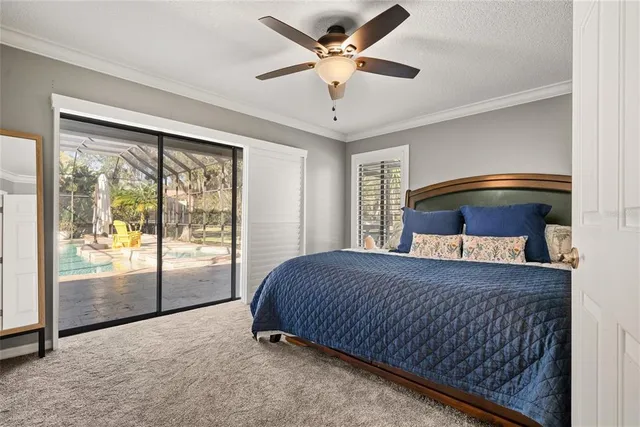 a bedroom with a bed and large window