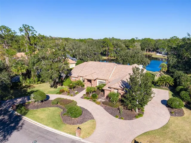 an aerial view of a house with swimming pool and mountains
