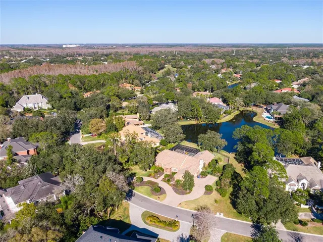an aerial view of lake and residential houses with outdoor space