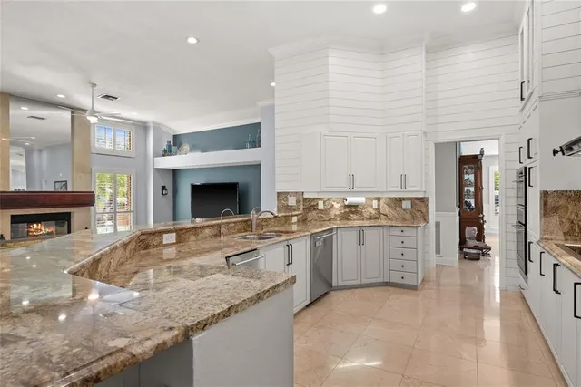 a kitchen with granite countertop a sink stove and refrigerator