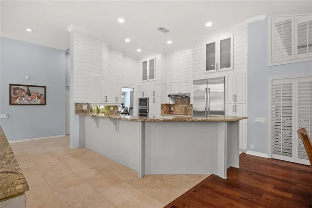 a kitchen with stainless steel appliances granite countertop a sink and cabinets