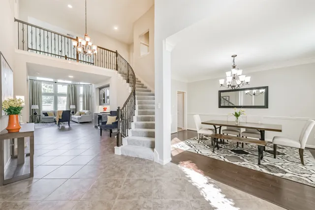 a living room with furniture and a chandelier