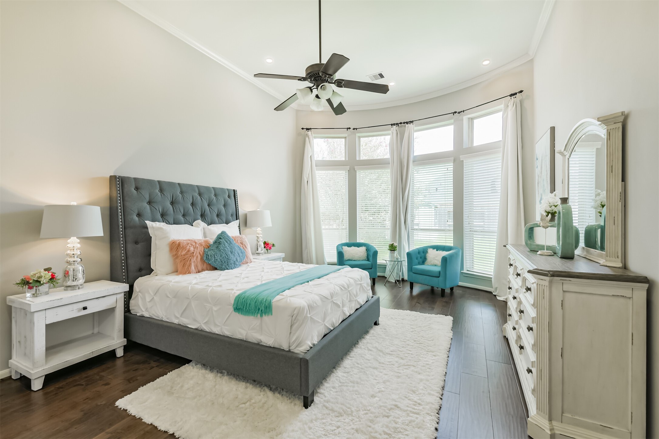 13519 Brant Grove Lane Houston, TX 77044 - Photo 22 of 49 a bedroom with a bed a large window and a chandelier