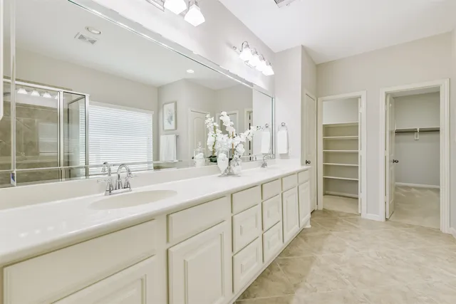a bathroom with a double vanity sink and a mirror