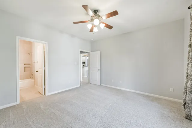 an empty room with fan and a ceiling fan