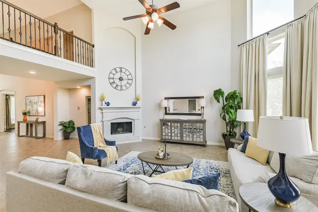 a living room with furniture a fireplace and a flat screen tv