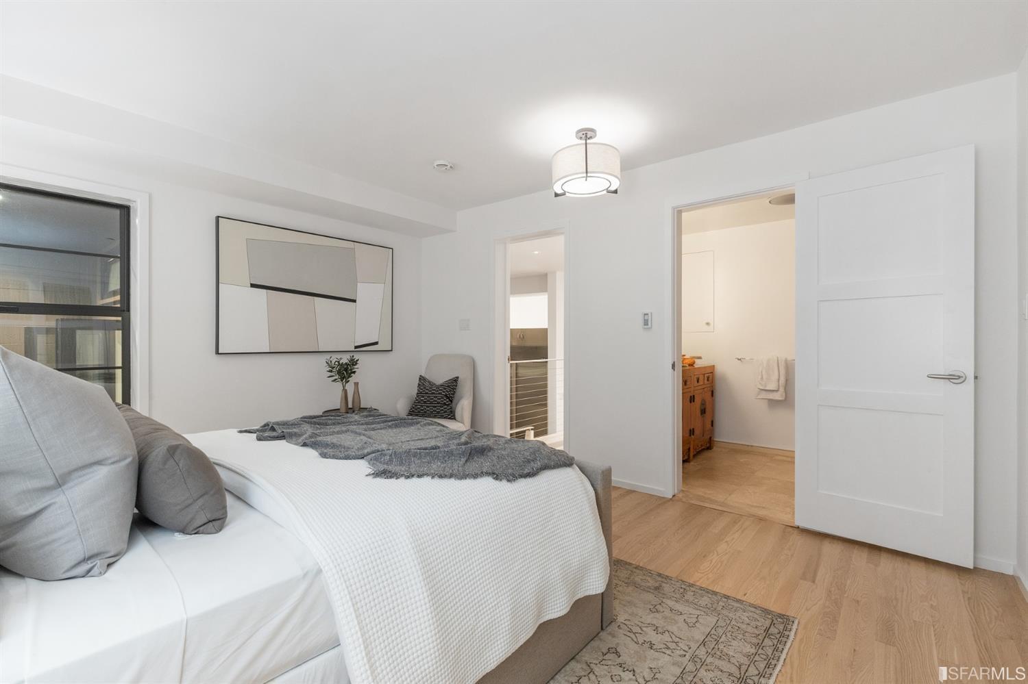 2 Fallon Place, Unit 15 San Francisco, CA 94133 - Photo 19 of 43 a bedroom with a bed and a chandelier