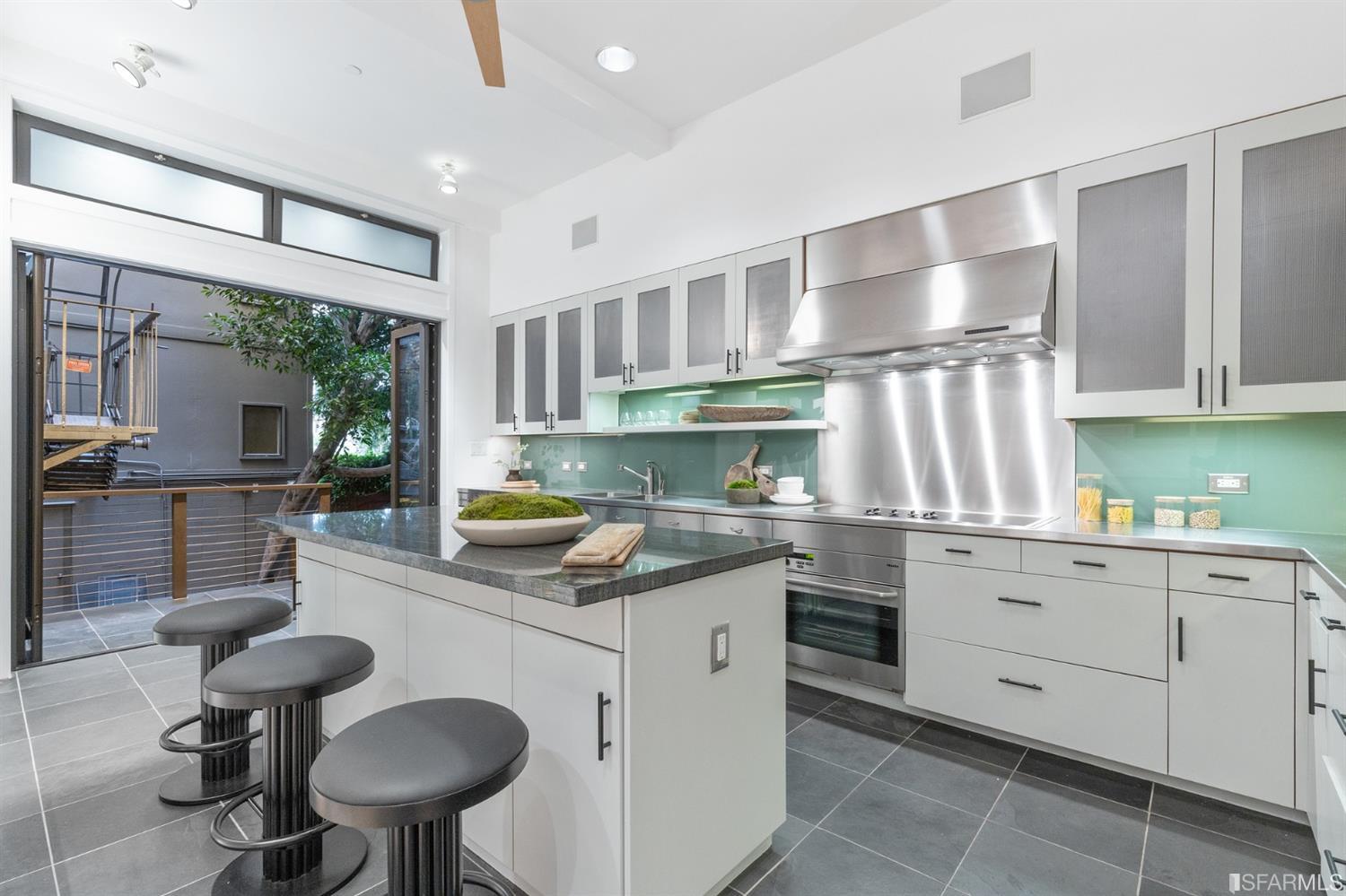 2 Fallon Place, Unit 15 San Francisco, CA 94133 - Photo 24 of 43 a kitchen with a cabinets a table and chairs in it