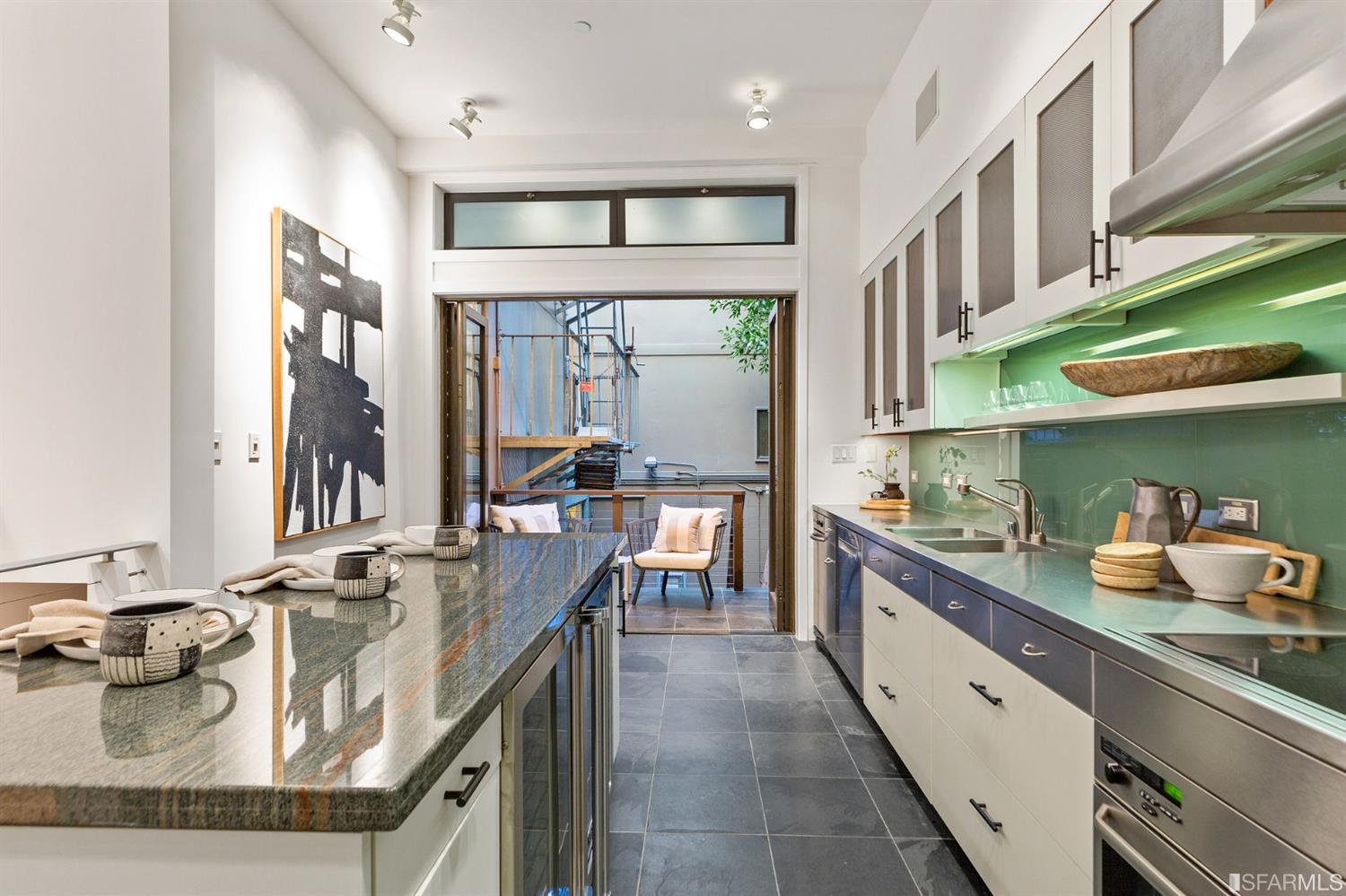 2 Fallon Place, Unit 15 San Francisco, CA 94133 - Photo 31 of 43 a large kitchen with stainless steel appliances granite countertop a lot of counter space and a sink