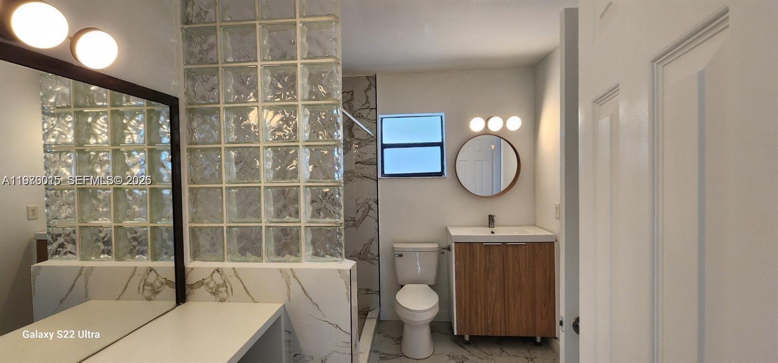 11321 Southwest 65th Street Miami, FL 33173 - Photo 19 of 24 a bathroom with a sink toilet and shower