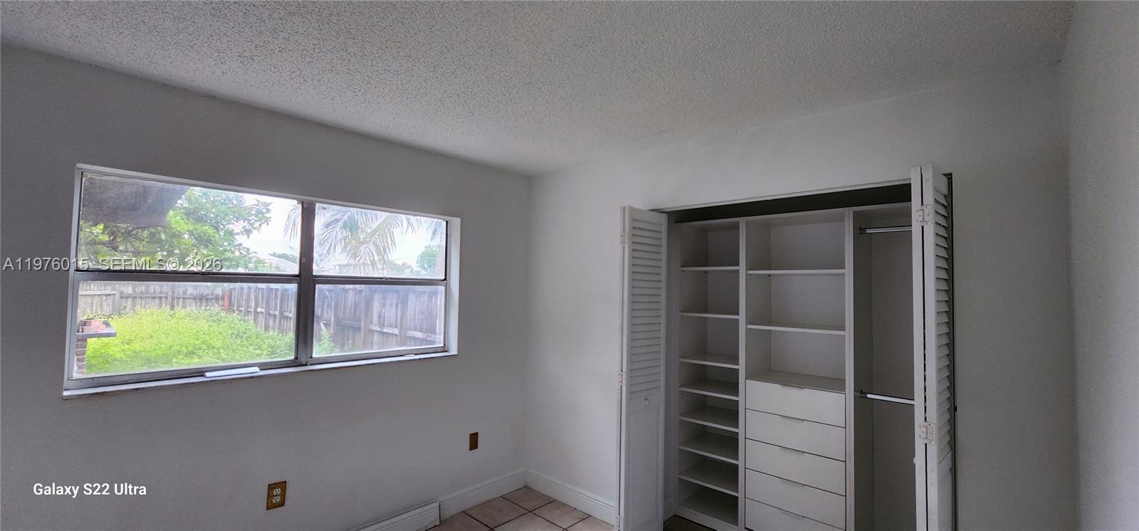 11321 Southwest 65th Street Miami, FL 33173 - Photo 10 of 24 a view of an empty room with a window