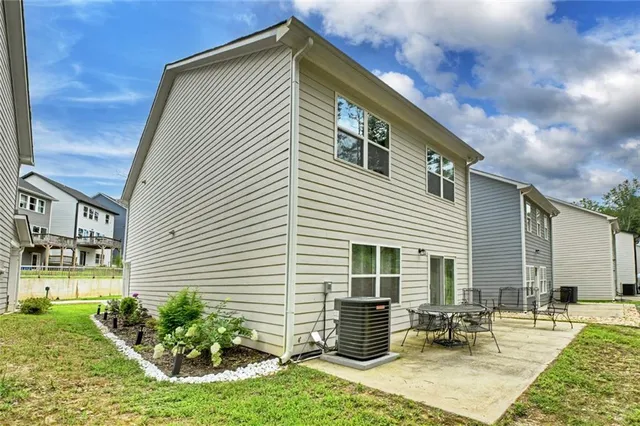 a backyard of a house with outdoor seating
