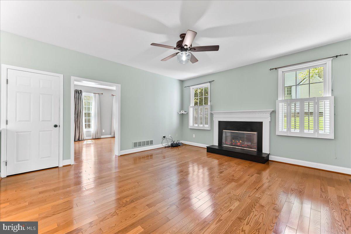 233 Chaingate Circle Landenberg, PA 19350 - Photo 7 of 31 a view of an empty room with wooden floor fireplace and a window