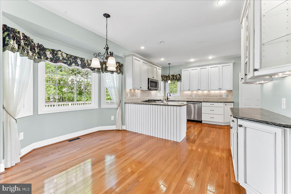 233 Chaingate Circle Landenberg, PA 19350 - Photo 8 of 31 a kitchen with stainless steel appliances granite countertop a sink window and a refrigerator