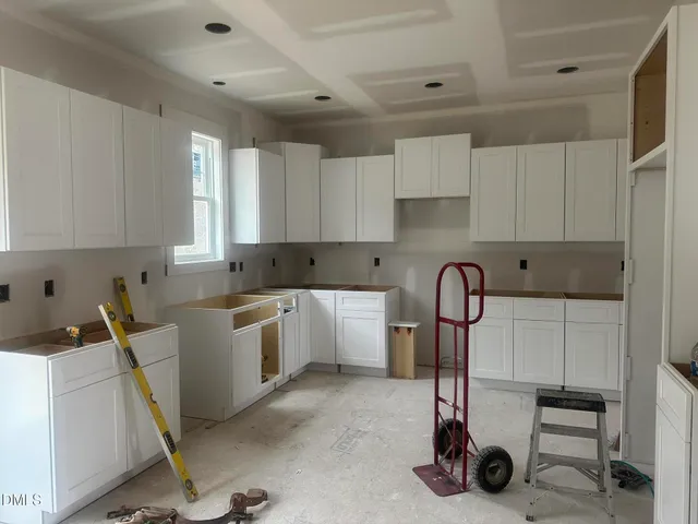 a kitchen with a refrigerator a sink and cabinets