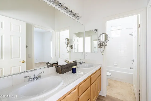 a bathroom with a sink double vanity and a mirror