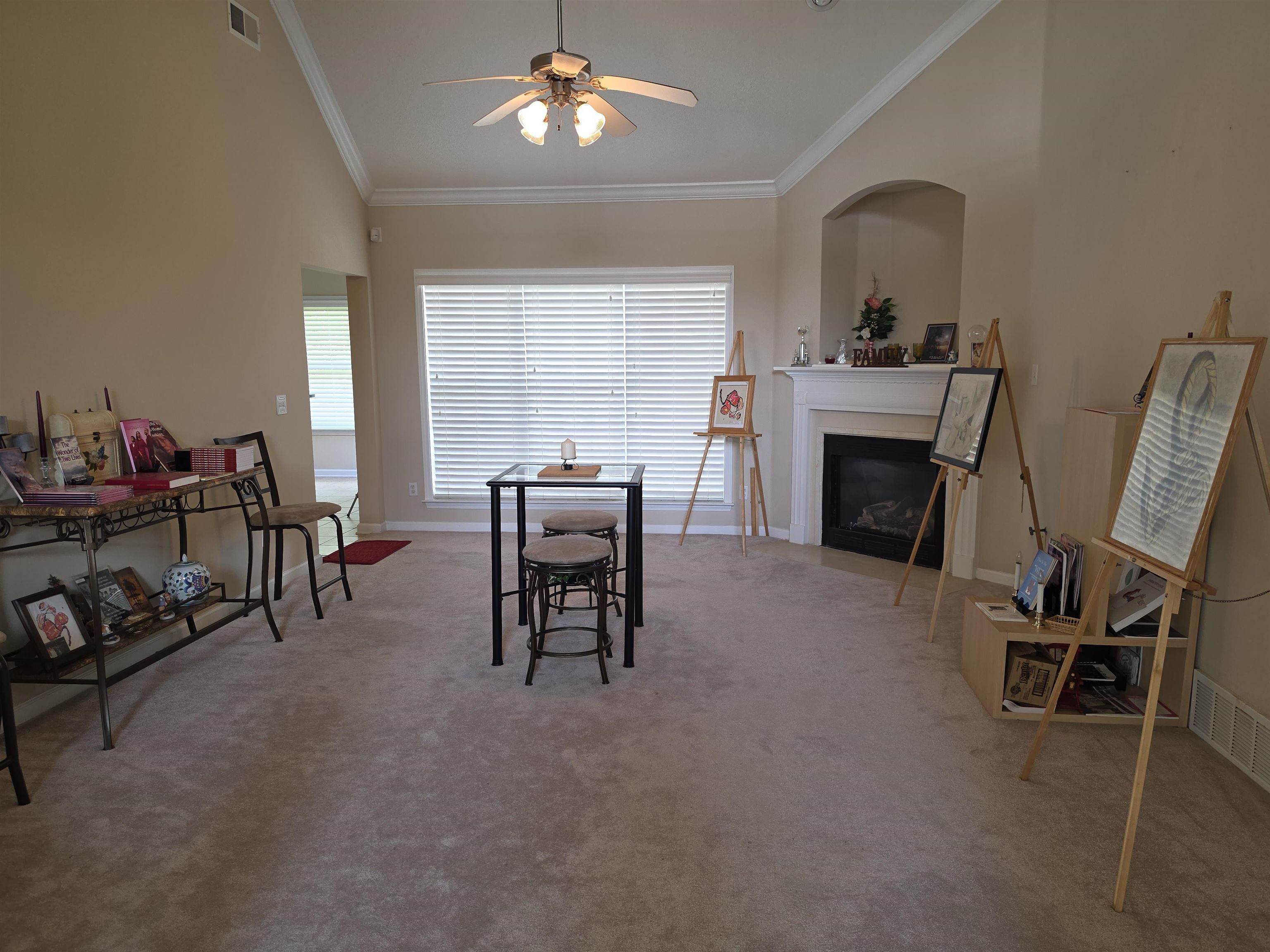 7253 Rourke Circle Memphis, TN 38125 - Photo 4 of 31 Vaulted ceilings with crown molding, a ceiling fan, and a fireplace with a mantelpiece