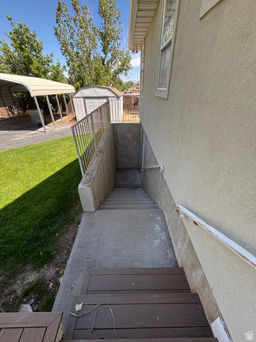 798 South 600 East Payson, UT 84651 - Photo 9 of 31 Exterior access to lower level featuring concrete steps, metal railing, and a stucco-finish wall