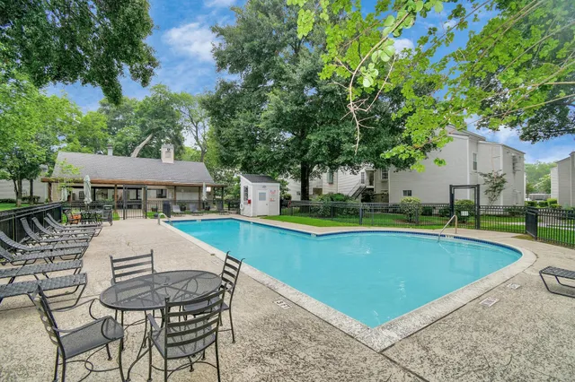 a view of a house with pool and chairs