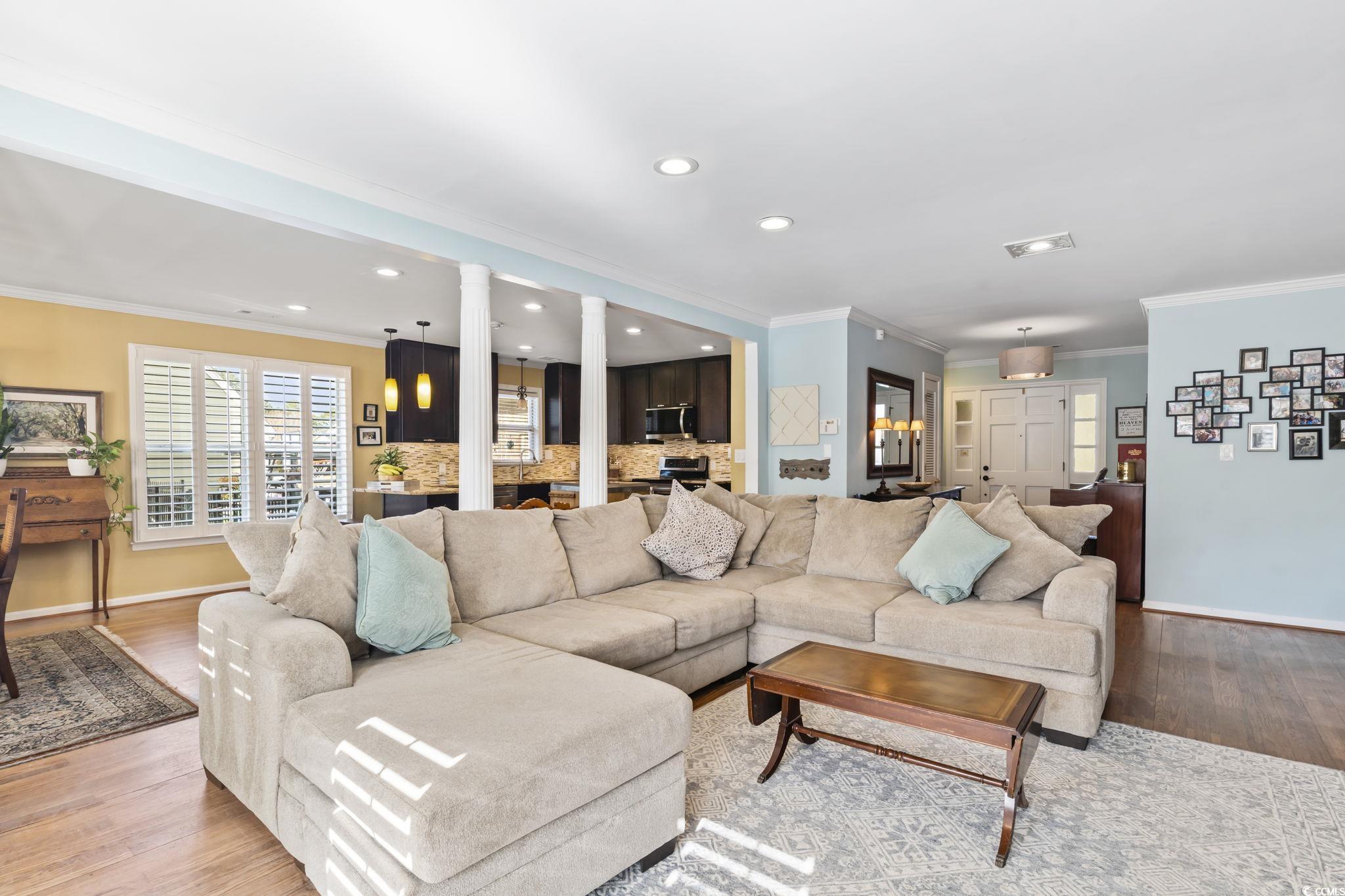 1671 Arundel Road Myrtle Beach, SC 29577 - Photo 20 of 40 Living room with decorative columns, light hardwoo