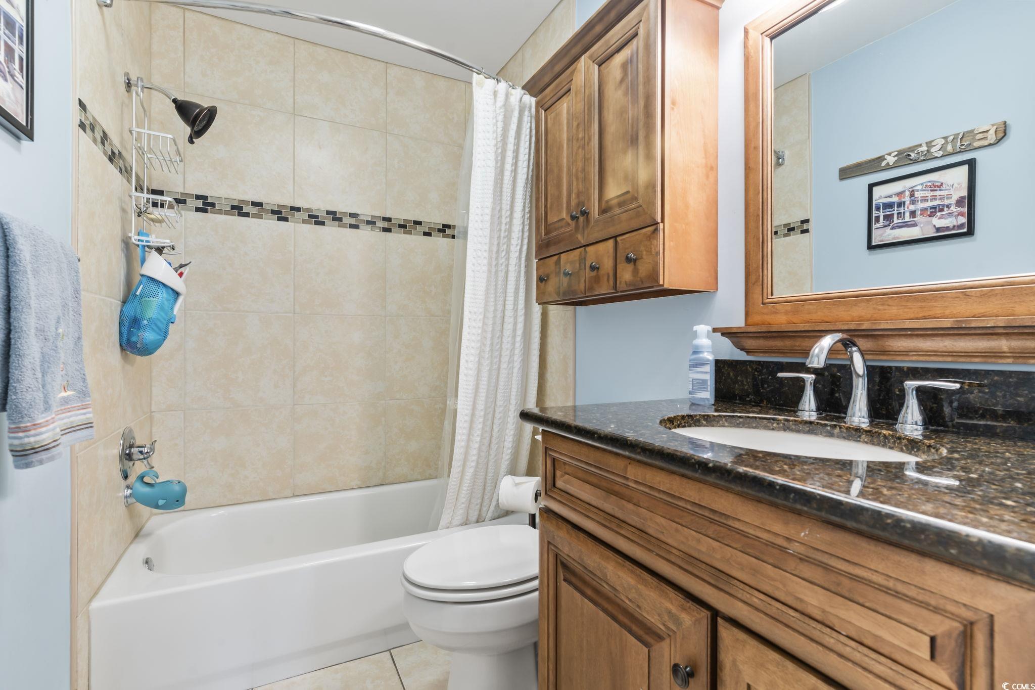 1671 Arundel Road Myrtle Beach, SC 29577 - Photo 8 of 40 Full bathroom featuring toilet, tile patterned flo