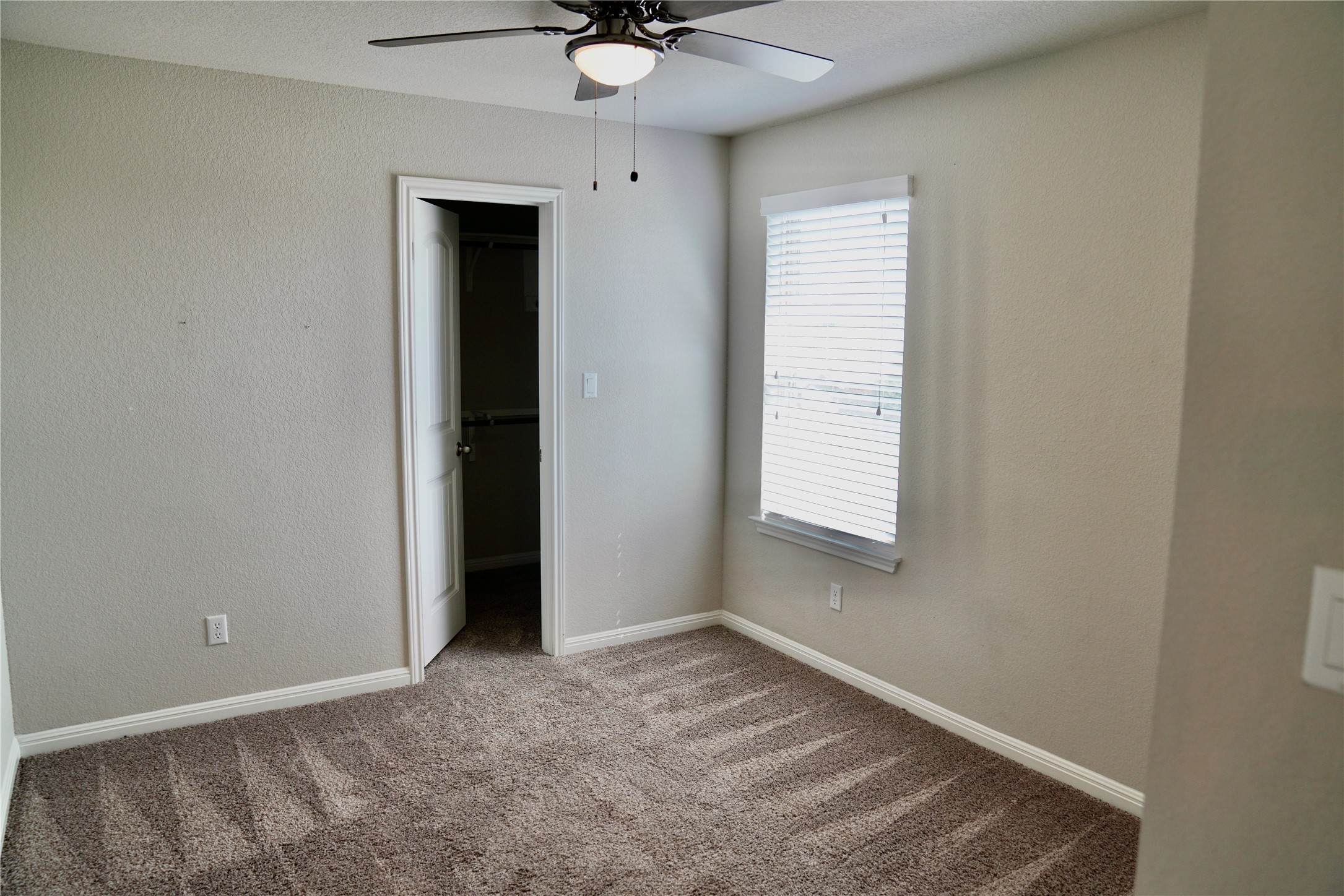 19028 Quebrada Drive Pflugerville, TX 78660 - Photo 24 of 36 an empty room with a window and a ceiling fan