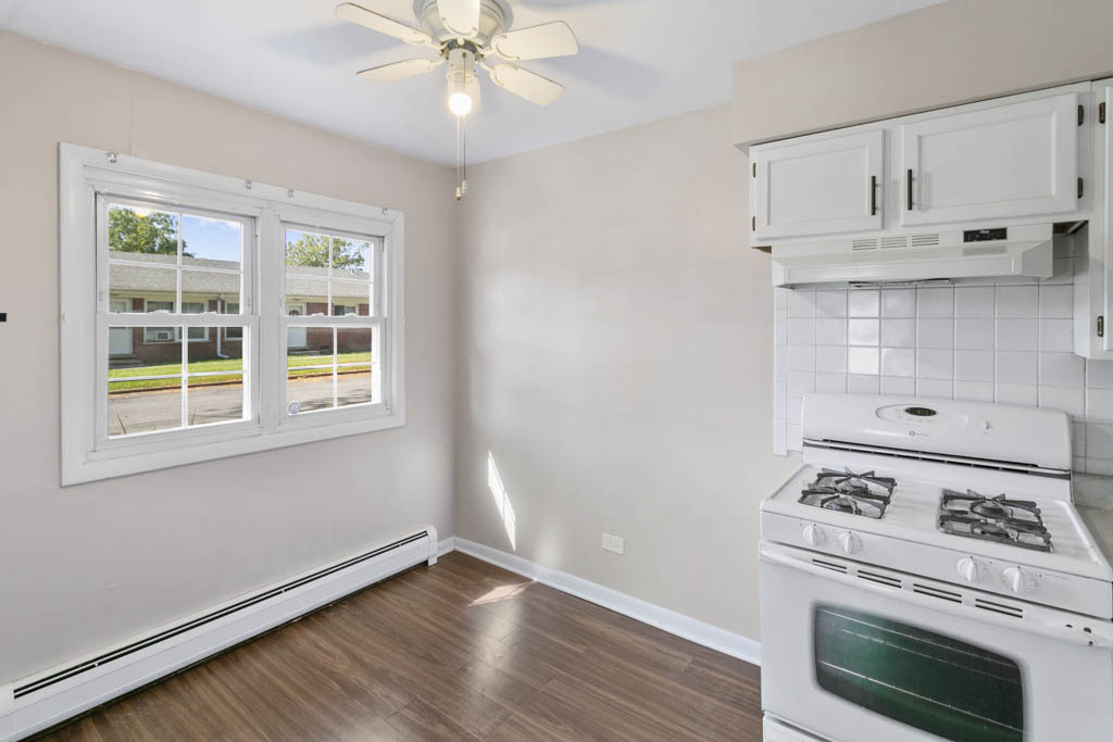 11212 1st Street, Unit 1 Mokena, IL 60448 - Photo 3 of 10 a kitchen with white cabinets and appliances
