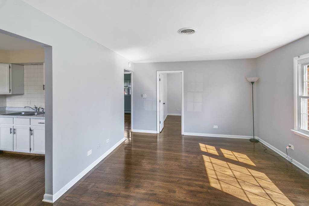 11212 1st Street, Unit 1 Mokena, IL 60448 - Photo 4 of 10 a view of empty room with wooden floor and cabinet