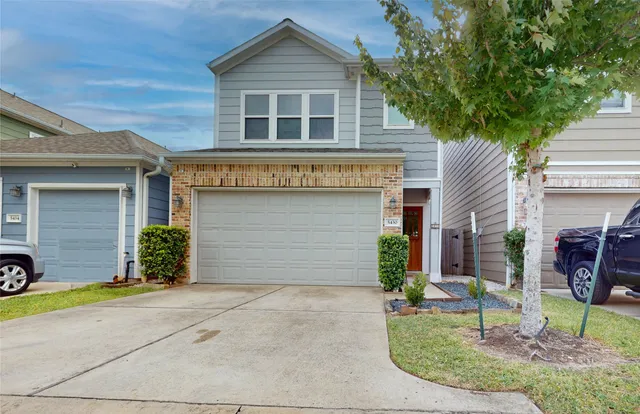 a dining room with wooden floor a chandelier a glass table and chairs